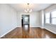 Bright dining room featuring hardwood floors, modern light fixture, and natural light from the large windows at 920 E Tabor St, Indianapolis, IN 46203