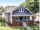 Charming two-story home with brick accents, lush landscaping, and a welcoming front porch at 920 E Tabor St, Indianapolis, IN 46203