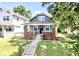 Charming two-story home with brick accents, a well-manicured lawn, and inviting curb appeal at 920 E Tabor St, Indianapolis, IN 46203