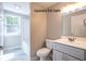 Full bath with gray finishes, large window, and recessed lighting at 920 E Tabor St, Indianapolis, IN 46203