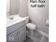 Half bath featuring a gray vanity and grey tile flooring at 920 E Tabor St, Indianapolis, IN 46203