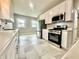 Bright kitchen featuring stainless steel appliances, light gray walls and marble countertops at 920 E Tabor St, Indianapolis, IN 46203