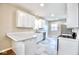 This modern kitchen features white cabinets, stainless steel appliances, and marble countertops at 920 E Tabor St, Indianapolis, IN 46203