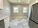 Bright kitchen area featuring stainless steel appliances, white cabinets, and large windows at 920 E Tabor St, Indianapolis, IN 46203