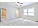 Large bedroom with a ceiling fan, walk-in closet, en suite bathroom, and carpet flooring at 920 E Tabor St, Indianapolis, IN 46203