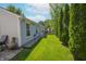 Backyard featuring a paved patio with a strip of grass and trees at 9774 Foxboro Ln, Fishers, IN 46038