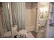 Bright bathroom featuring a tub with shower, toilet, and ample natural light at 9774 Foxboro Ln, Fishers, IN 46038