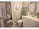 This bathroom features neutral paint, a white vanity, a stylish mirror, and a toilet at 9774 Foxboro Ln, Fishers, IN 46038