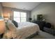 Cozy bedroom offers a comfortable bed, modern furnishings, and plenty of natural light at 9774 Foxboro Ln, Fishers, IN 46038