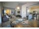 Open-concept dining area with a rustic wood table, seamlessly connects to the living room and kitchen at 9774 Foxboro Ln, Fishers, IN 46038