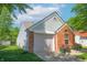 Charming single Gathering home with brick facade, attached garage, and well-maintained side yard at 9774 Foxboro Ln, Fishers, IN 46038