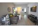 Inviting living room features a comfortable gray sectional sofa, stylish decor, and a large flat-screen television at 9774 Foxboro Ln, Fishers, IN 46038