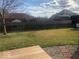 Fenced backyard with grass area, fire pit, and a wooden deck perfect for outdoor entertaining at 1045 Springway Dr, Shelbyville, IN 46176