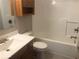 Bathroom features a tub and shower combo with wood vanity and cabinet at 1045 Springway Dr, Shelbyville, IN 46176