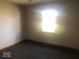 Bedroom featuring neutral walls, a window offering natural light, and carpeted flooring at 1045 Springway Dr, Shelbyville, IN 46176