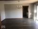 Dining room with a chandelier and laminate floors leads to the kitchen and sliding glass door at 1045 Springway Dr, Shelbyville, IN 46176