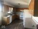 Functional kitchen with white appliances, wood cabinets, and ample counter space at 1045 Springway Dr, Shelbyville, IN 46176