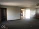 Living room view showcases open doorway to the kitchen and wood trim at 1045 Springway Dr, Shelbyville, IN 46176