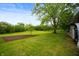 Expansive backyard featuring lush green lawn, mature trees, and open space, offering privacy and serenity at 11720 S County Road 396 E, Muncie, IN 47302