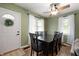 Well-lit dining room featuring a dark wood table, matching chairs, and a ceiling fan at 11720 S County Road 396 E, Muncie, IN 47302