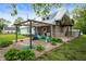 Exterior showing a balcony, a metal roof and a pergola covered patio with playful outdoor furniture at 11720 S County Road 396 E, Muncie, IN 47302