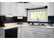 Well-lit kitchen featuring white cabinets, countertops, and modern appliances at 11720 S County Road 396 E, Muncie, IN 47302