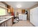 Spacious laundry area with washer, dryer, water heater, utility sink, and ample storage for household tasks at 11720 S County Road 396 E, Muncie, IN 47302
