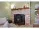 Cozy living room with a brick fireplace, mantel, and light green walls at 11720 S County Road 396 E, Muncie, IN 47302