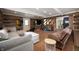Spacious basement living area featuring log walls, recessed lighting, and cozy seating at 11720 S County Road 396 E, Muncie, IN 47302