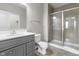 Well-lit bathroom with walk-in shower, gray vanity, and updated finishes at 11815 Adair Pl, Indianapolis, IN 46229