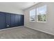 Bright bedroom featuring modern accent wall, neutral carpet and natural light at 11815 Adair Pl, Indianapolis, IN 46229