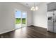 Bright dining area features stainless steel refrigerator and sliding glass door to the outdoors at 11815 Adair Pl, Indianapolis, IN 46229