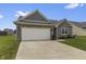 Charming single-Gathering home featuring a two-car garage, brick facade, and well-maintained lawn at 11815 Adair Pl, Indianapolis, IN 46229