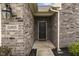 Inviting front entrance with brick exterior and modern lighting fixture at 11815 Adair Pl, Indianapolis, IN 46229