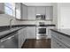 Stylish kitchen featuring stainless steel appliances, grey cabinets, granite countertops, and modern finishes at 11815 Adair Pl, Indianapolis, IN 46229