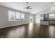 Open-concept living and kitchen area with hardwood floors and large windows offering backyard views at 11815 Adair Pl, Indianapolis, IN 46229