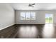 Spacious living room with hardwood floors, lots of natural light, and access to backyard patio at 11815 Adair Pl, Indianapolis, IN 46229