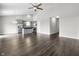 Open living space with a kitchen featuring grey cabinets, stainless appliances, and wood-look flooring at 11815 Adair Pl, Indianapolis, IN 46229