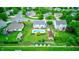 Overhead shot of backyard oasis with a swimming pool, patio area, and surrounded by verdant landscaping at 1199 Oak Leaf Rd, Franklin, IN 46131