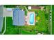 Aerial view of a backyard featuring a private pool, lush green lawn, and a well-maintained wooden fence at 1199 Oak Leaf Rd, Franklin, IN 46131