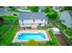 Aerial view of a backyard featuring a pool, patio with furniture, and lush green landscaping at 1199 Oak Leaf Rd, Franklin, IN 46131