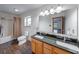 Bathroom with double sink vanity, tub-shower, window, and wood-look floors at 1199 Oak Leaf Rd, Franklin, IN 46131