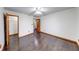 This bedroom features a ceiling fan, closet, and wood-look flooring at 1199 Oak Leaf Rd, Franklin, IN 46131