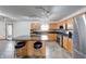 Open kitchen with stainless steel appliances, black granite countertops, and island seating at 1199 Oak Leaf Rd, Franklin, IN 46131