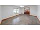 Empty living room with a staircase, large window, and neutral tile flooring at 1199 Oak Leaf Rd, Franklin, IN 46131