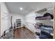 Walk-in closet featuring dark wood floors, adjustable metal shelving and clothing at 1199 Oak Leaf Rd, Franklin, IN 46131