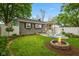 Charming backyard featuring a fire pit, pergola, patio, and a well-maintained lawn at 1240 Hamilton Dr, Noblesville, IN 46060