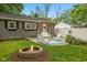 Cozy backyard features a fire pit, patio seating, pergola, and privacy fence at 1240 Hamilton Dr, Noblesville, IN 46060