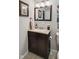 Elegant powder room features a granite countertop and dark wood vanity at 1240 Hamilton Dr, Noblesville, IN 46060