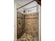 Beautifully tiled shower with glass block window and bronze fixtures in the remodeled bathroom at 1240 Hamilton Dr, Noblesville, IN 46060